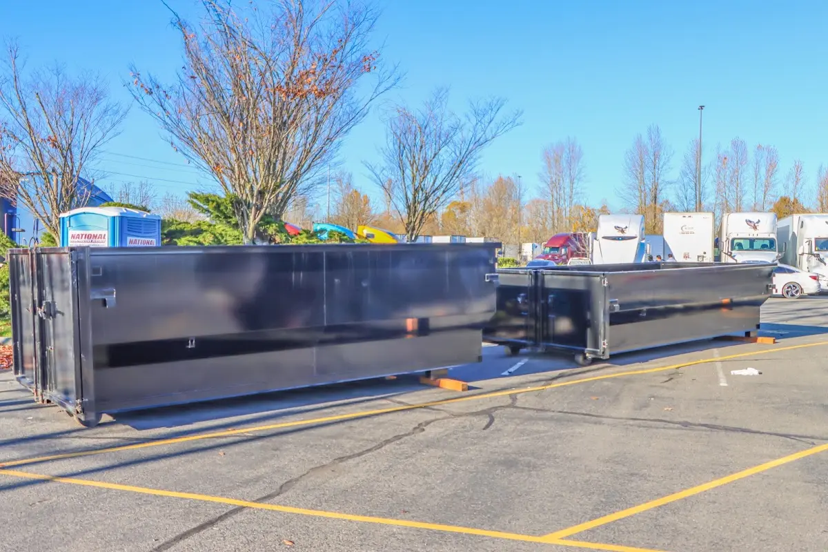 Professional dumpster rental service with roll-off container on residential driveway in Texarkana